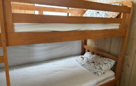 a set of bunks and a fold-out bed in second room